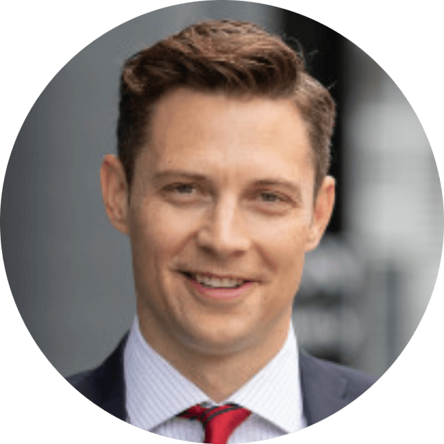 Cash Offer's Aaron Dow; headshot with dark grey suit and red tie